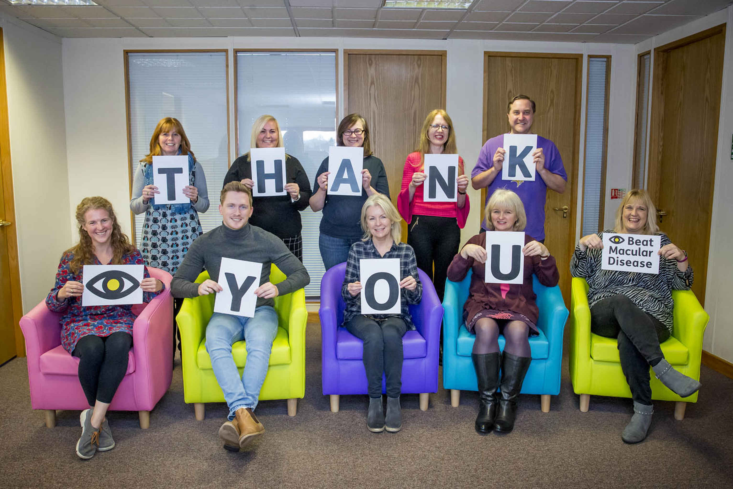 Macular Society team holding cards spelling "thank you" 
