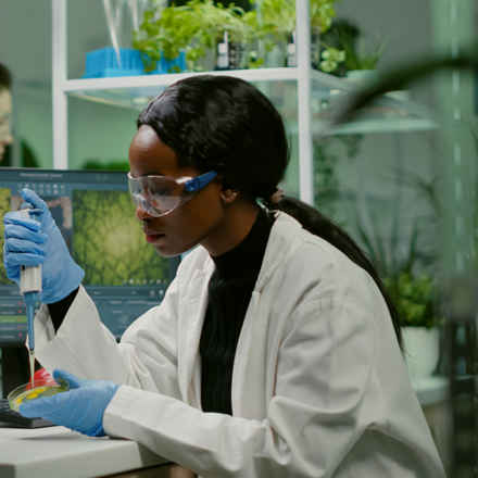 scientist researching surrounded by plants