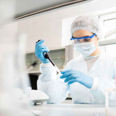 Researcher working in mask, gloves, goggles
